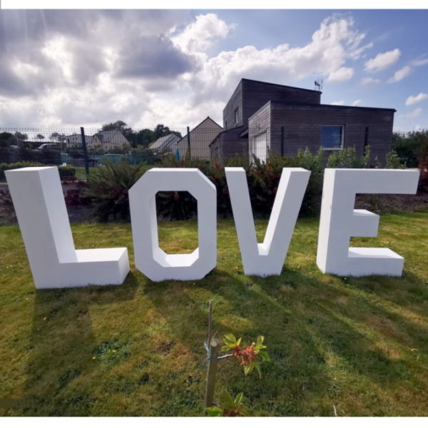 Lettres géantes LOVE en location, posées dans un jardin